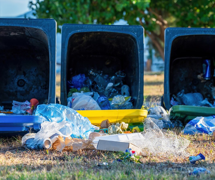 Three bins filled with trash ready for Port St Lucie garbage pickup